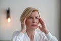 Midaged blone woman suffering from a headache Royalty Free Stock Photo