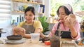 Middle agd woman painting on handicraft crockery at art workshop. Retirement, leisure activity, handicraft, hobbies