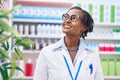 Middle age african american woman pharmacist smiling confident standing at pharmacy Royalty Free Stock Photo