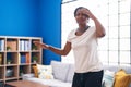 Middle age african american woman suffering dizzy standing at home
