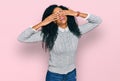 Middle age african american woman wearing casual clothes covering eyes with hands smiling cheerful and funny Royalty Free Stock Photo