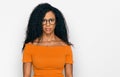 Middle age african american woman wearing casual clothes and glasses relaxed with serious expression on face Royalty Free Stock Photo