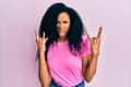 Middle age african american woman wearing casual clothes shouting with crazy expression doing rock symbol with hands up Royalty Free Stock Photo