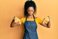 Middle age african american woman wearing professional apron pointing down looking sad and upset, indicating direction with Royalty Free Stock Photo