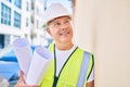 Middle age architect man holding blueprints leaning on the wall at the city Royalty Free Stock Photo