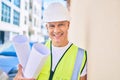 Middle age architect man holding blueprints leaning on the wall at the city Royalty Free Stock Photo