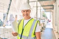 Middle age architect man holding blueprints walking at the city Royalty Free Stock Photo