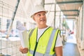 Middle age architect man holding blueprints walking at the city Royalty Free Stock Photo