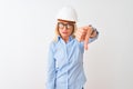 Middle age architect woman wearing glasses and helmet over isolated white background looking unhappy and angry showing rejection Royalty Free Stock Photo