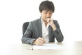 Middle age Asian businessman writing document report in the office. Signing contract. Royalty Free Stock Photo