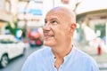 Middle age bald man smiling happy walking at the city Royalty Free Stock Photo