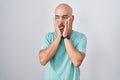 Middle age bald man standing over white background tired hands covering face, depression and sadness, upset and irritated for Royalty Free Stock Photo