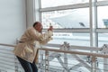 middle age bald man taking photo with smart phone in waiting room at port - Happy tourist traveling by cruise ship Royalty Free Stock Photo