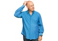 Middle age bald man wearing casual clothes confuse and wondering about question Royalty Free Stock Photo