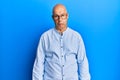 Middle age bald man wearing casual clothes and glasses depressed and worry for distress, crying angry and afraid Royalty Free Stock Photo