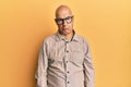 Middle age bald man wearing casual clothes and glasses depressed and worry for distress, crying angry and afraid Royalty Free Stock Photo