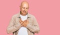 Middle age bald man wearing casual clothes smiling with hands on chest with closed eyes and grateful gesture on face Royalty Free Stock Photo