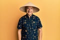 Middle age bald man wearing traditional asian straw hat with a happy and cool smile on face Royalty Free Stock Photo