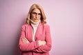 Middle age beautiful blonde business woman wearing elegant pink jacket and glasses skeptic and nervous, disapproving expression on Royalty Free Stock Photo