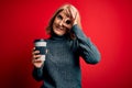 Middle age beautiful blonde woman drinking takeaway cup of coffee over red background with happy face smiling doing ok sign with Royalty Free Stock Photo