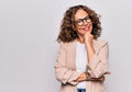 Middle age beautiful businesswoman wearing glasses standing over isolated white background smiling looking confident at the camera Royalty Free Stock Photo