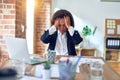 Middle age beautiful businesswoman working using laptop at the office suffering from headache desperate and stressed because pain Royalty Free Stock Photo