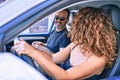 Middle age beautiful couple on vacation wearing sunglasses smiling happy driving car Royalty Free Stock Photo