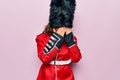 Middle age beautiful wales guard woman wearing traditional uniform over pink background with sad expression covering face with Royalty Free Stock Photo