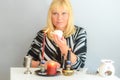 Portrait of beautiful middle age woman sits near a fortune teller desk with a tarot cards and candles. Royalty Free Stock Photo