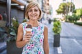 Middle age beautiful woman holding ice cream at park Royalty Free Stock Photo