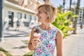 Middle age beautiful woman holding ice cream at park Royalty Free Stock Photo