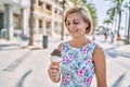 Middle age beautiful woman holding ice cream at park Royalty Free Stock Photo