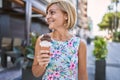 Middle age beautiful woman holding ice cream at park Royalty Free Stock Photo