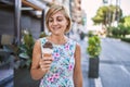 Middle age beautiful woman holding ice cream at park Royalty Free Stock Photo