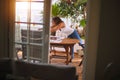 Middle age beautiful woman setting cutlery on table for brunch at terrace