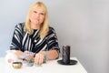 Portrait of beautiful middle age woman sits near a fortune teller desk with a tarot cards and candles. Royalty Free Stock Photo