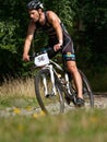 Middle age biker riding along the distance overcoming the descents