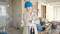 Middle age blonde woman architect smiling confident standing with arms crossed gesture at construction site Royalty Free Stock Photo