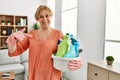 Middle age blonde woman holding cleaning products cleaning at home pointing finger to one self smiling happy and proud Royalty Free Stock Photo