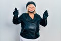 Middle age blonde woman holding motorcycle helmet gesturing finger crossed smiling with hope and eyes closed Royalty Free Stock Photo