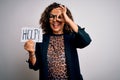 Middle age brunette business woman stressed holding banner with help word message with happy face smiling doing ok sign with hand Royalty Free Stock Photo