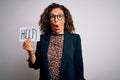 Middle age brunette business woman stressed holding banner with help word message scared in shock with a surprise face, afraid and Royalty Free Stock Photo