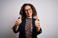 Middle age brunette business woman wearing glasses standing over isolated white background approving doing positive gesture with Royalty Free Stock Photo