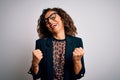 Middle age brunette business woman wearing glasses standing over isolated white background very happy and excited doing winner Royalty Free Stock Photo