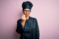 Middle age brunette chef woman wearing cooker uniform and hat over isolated pink background Doing Italian gesture with hand and Royalty Free Stock Photo