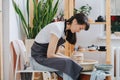 Potter making yet another vase on a pottery wheel in her private workshop