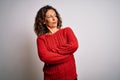 Middle age brunette woman wearing casual sweater standing over isolated white background looking to the side with arms crossed Royalty Free Stock Photo