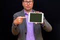 Middle age Business man holding and shows to tablet pc with blank screen Royalty Free Stock Photo