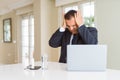 Middle age business man working with computer laptop suffering from headache desperate and stressed because pain and migraine Royalty Free Stock Photo