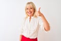 Middle age businesswoman wearing elegant shirt standing over isolated white background doing happy thumbs up gesture with hand Royalty Free Stock Photo